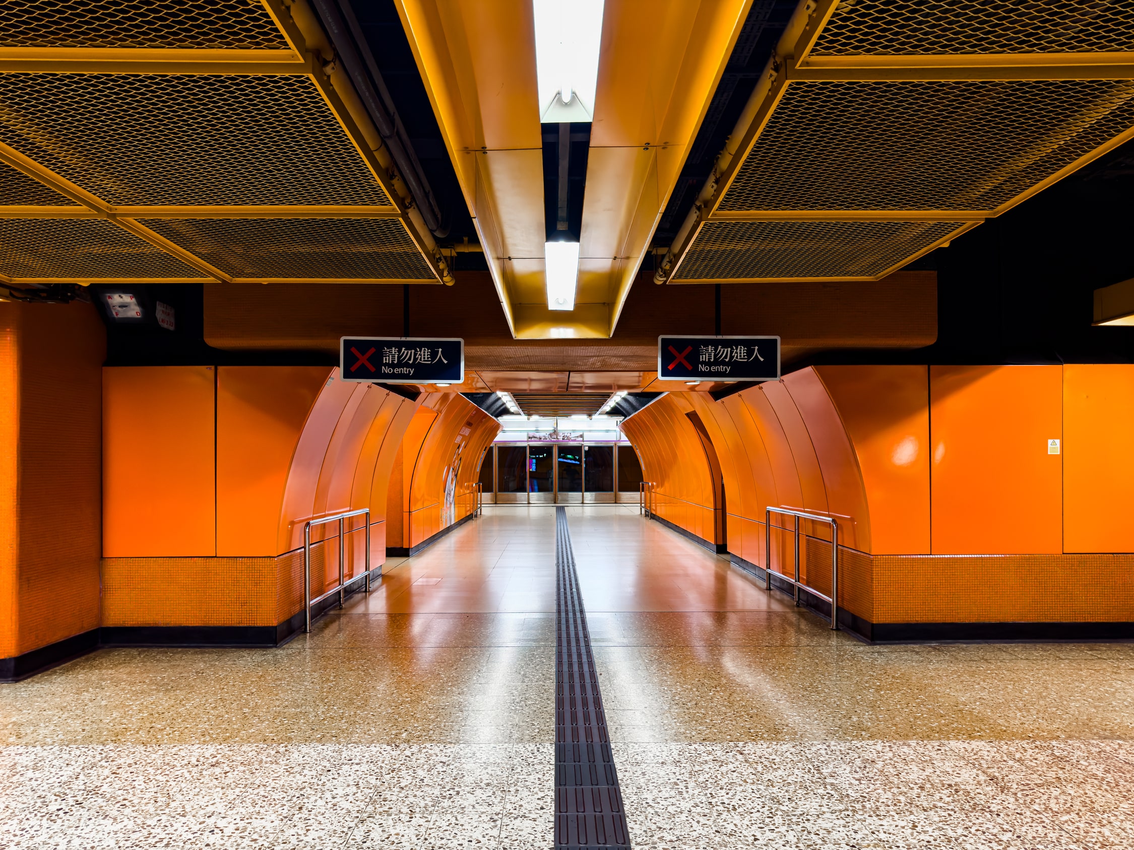 Tunnel eines U-Bahnhofs mit Blick in Richtung der Gleise.
